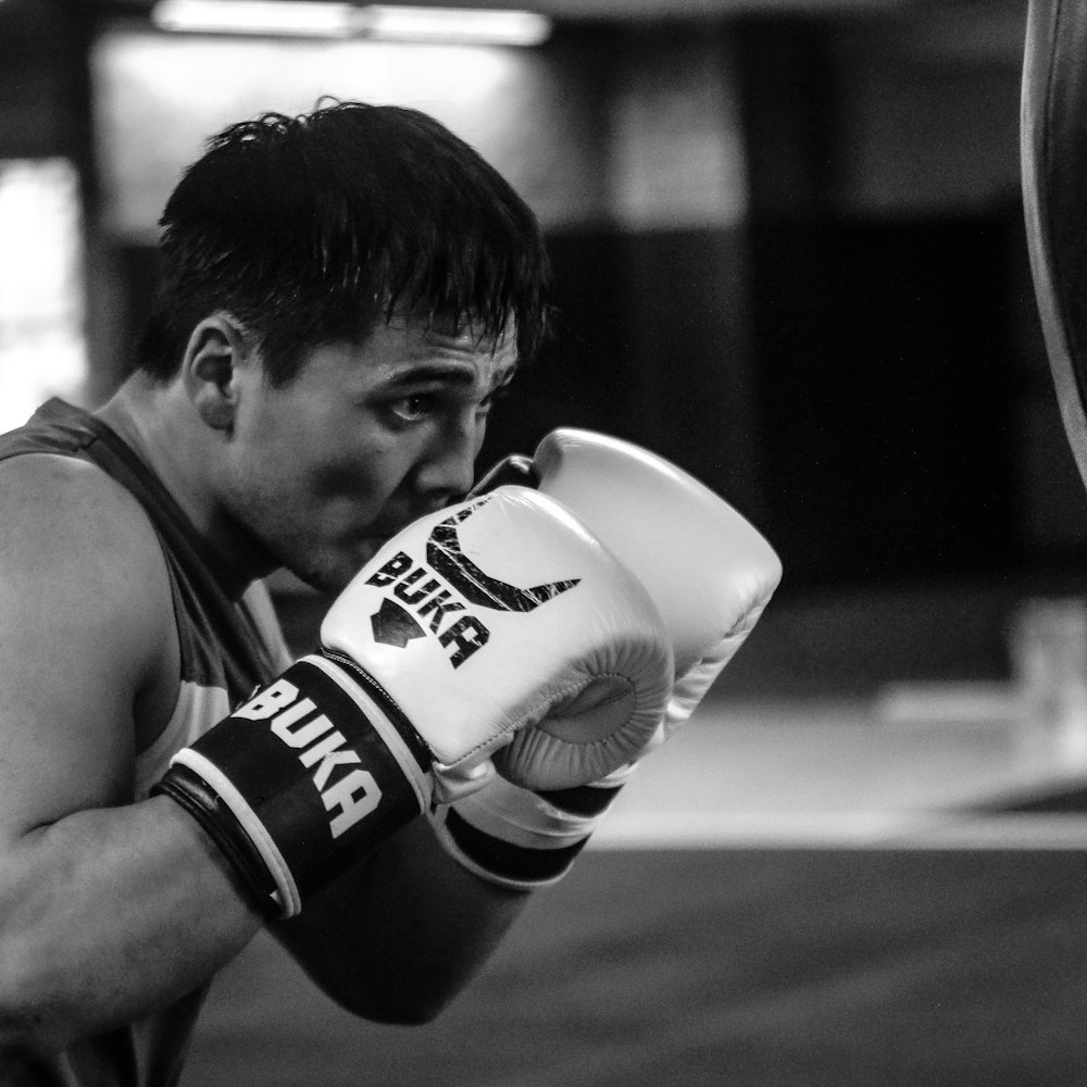 Person wearing boxing gloves in a gym