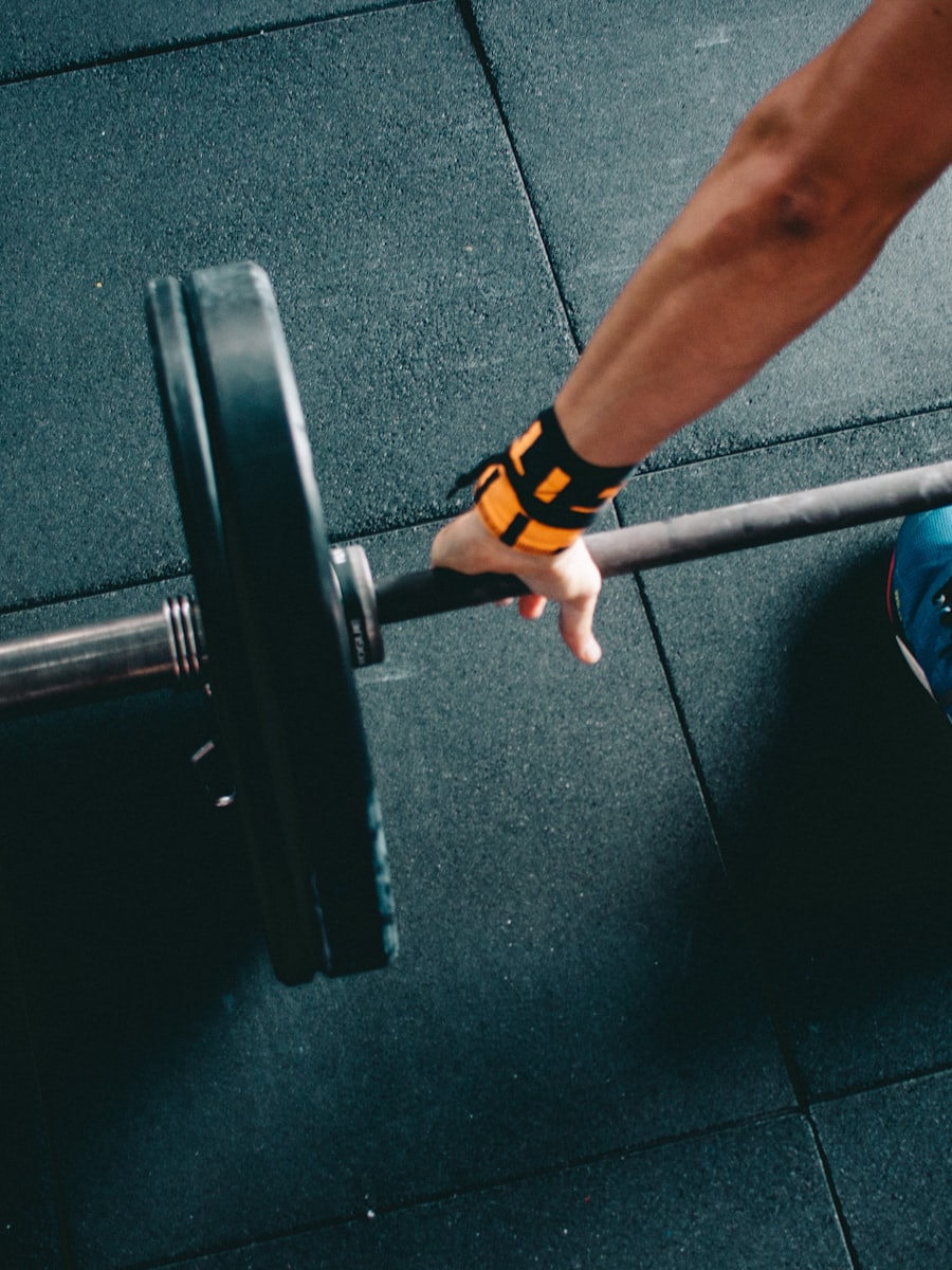 Portrait of a fitness trainer holding a barbell